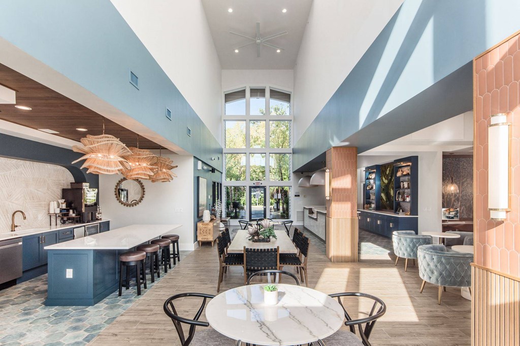 a large dining room with tables and chairs and a large window