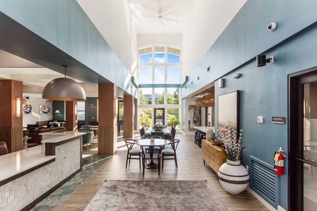 a dining room with a table and chairs and a large window