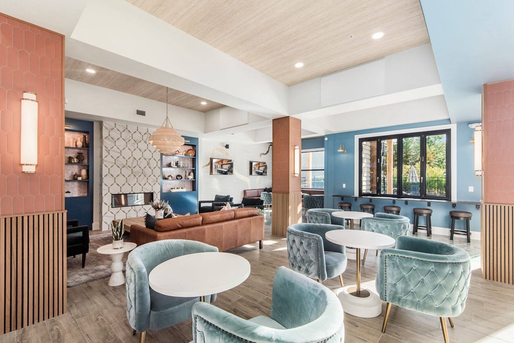 a lobby with blue chairs and couches and tables