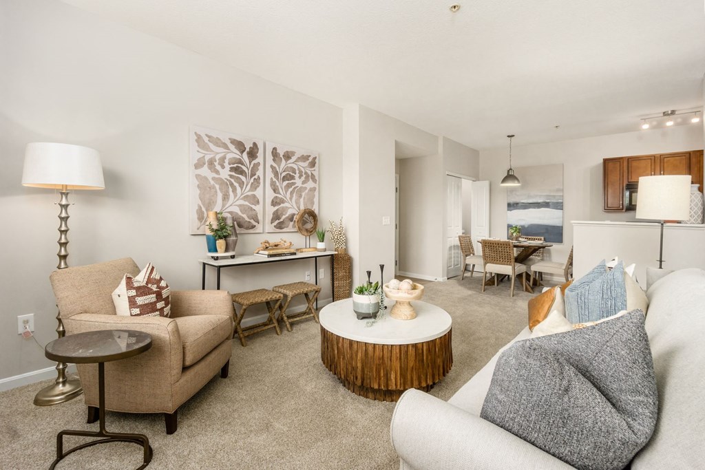 a living room with couches and chairs and a table