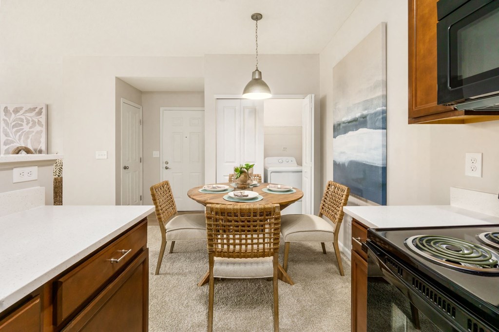 a kitchen and dining room with a table and chairs