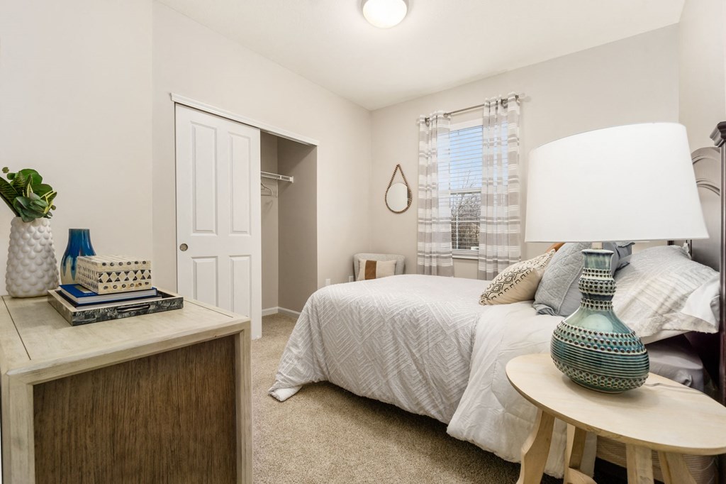 a bedroom with a bed and a dresser and a window