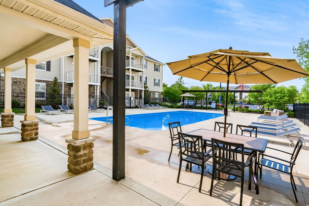 our apartments offer a swimming pool with tables and umbrellas