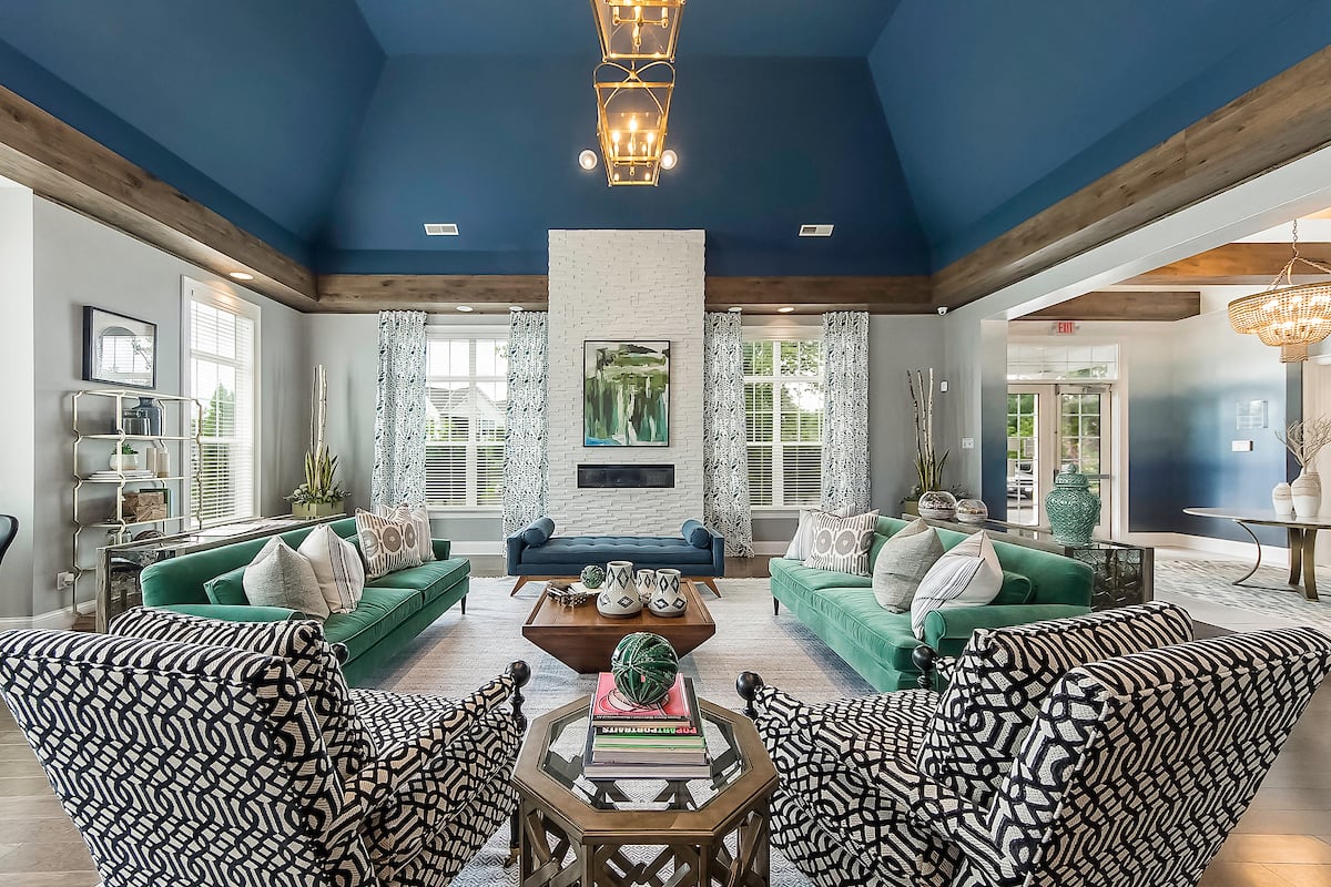 a living room with couches and chairs and a fireplace