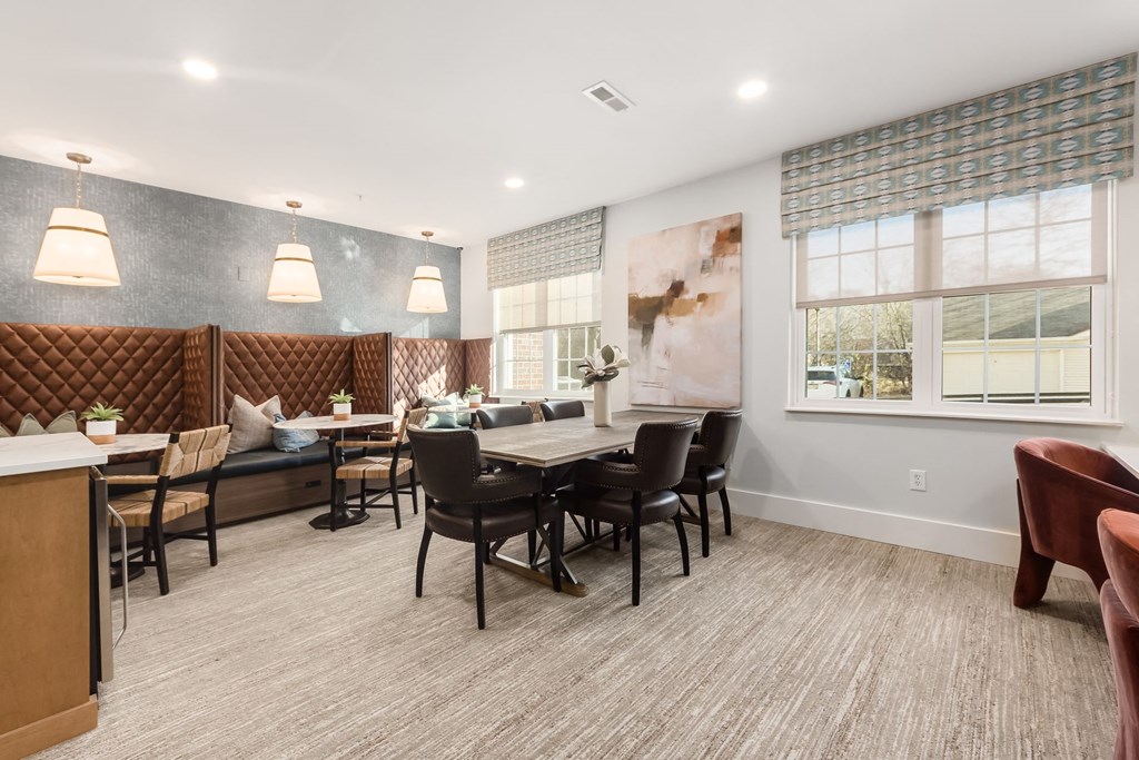 a dining room with a table and chairs and a window