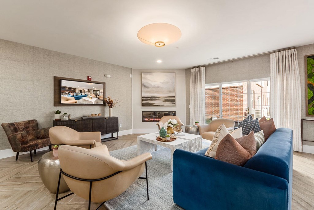 a living room with a blue couch and chairs