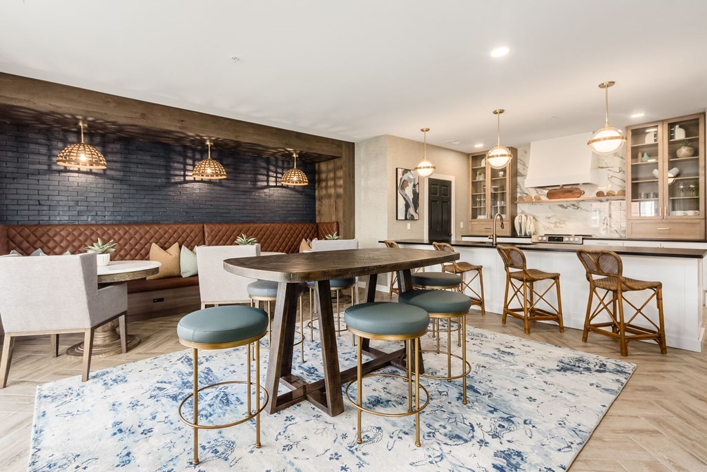 a dining area with a table and chairs and a kitchen