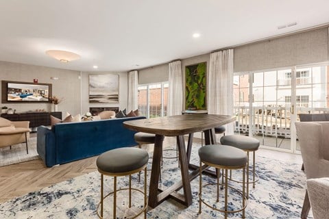 a living room with a round table and a blue couch