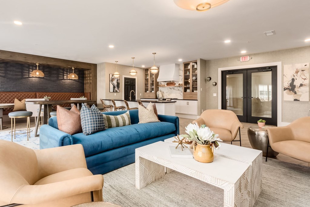 a living room with a blue couch and a table