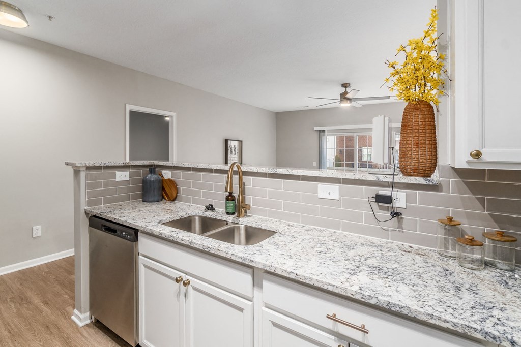 a kitchen with white cabinets and a sink