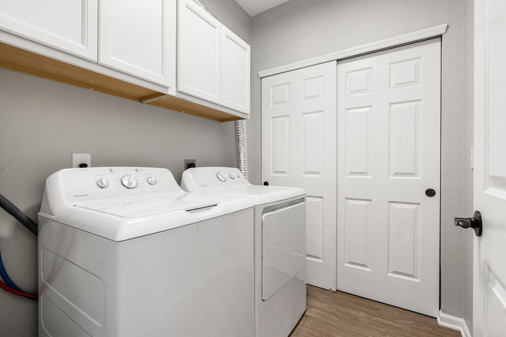 Residences of Gahanna spacious laundry room with washer and dryer included and cabinetry