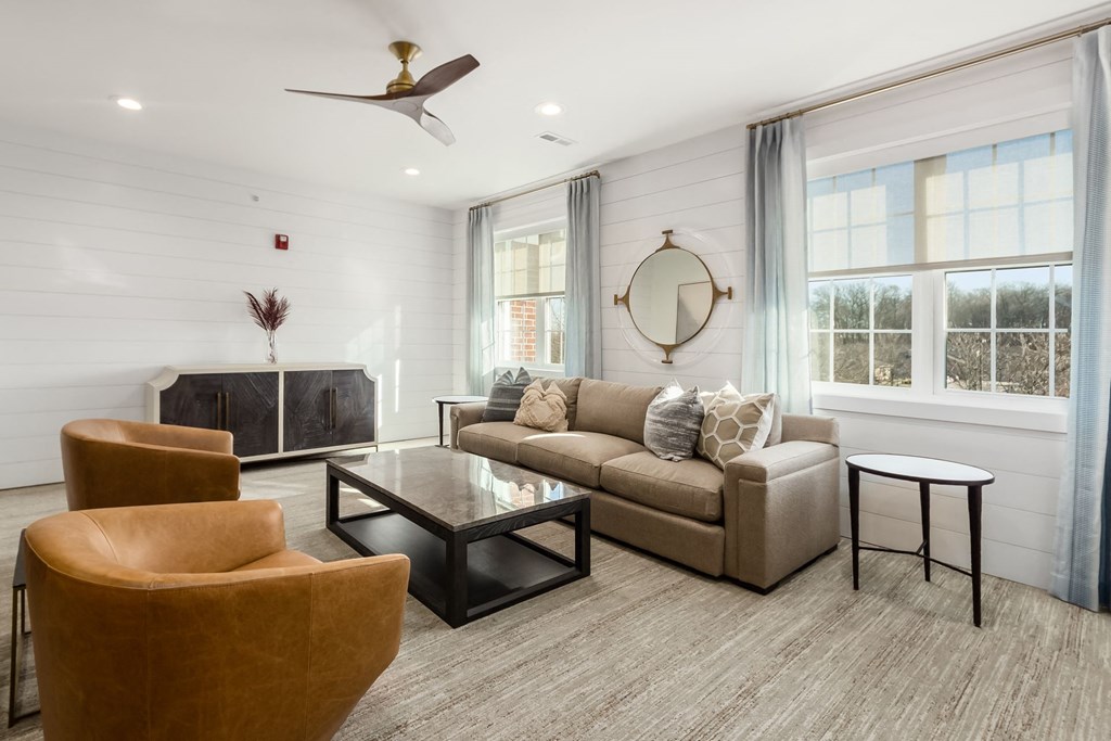 a living room with a couch and chairs and a table