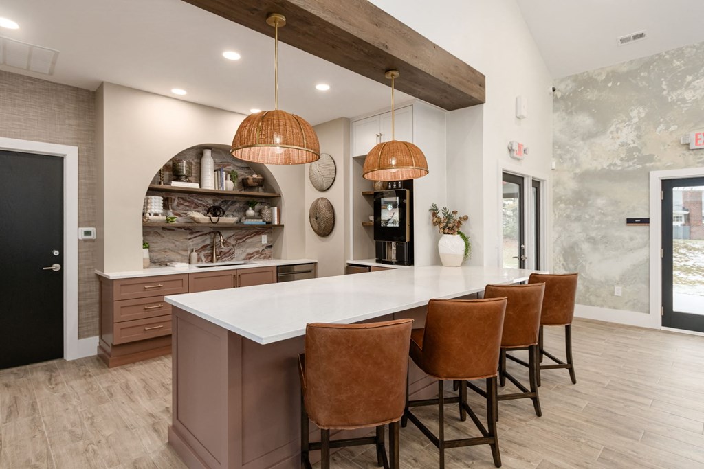 a kitchen with a large island and chairs