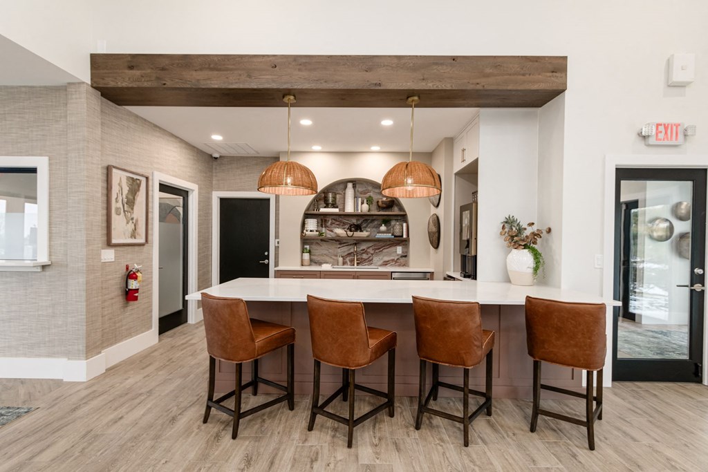 a kitchen with a large island and four chairs