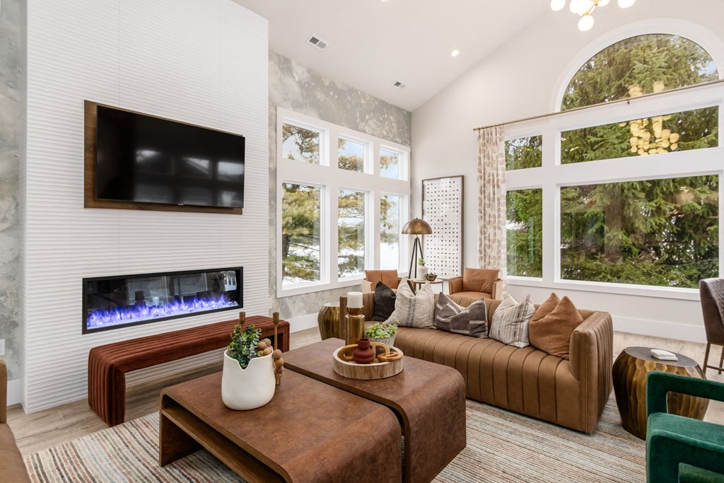 a living room with a couch and a television and a fireplace