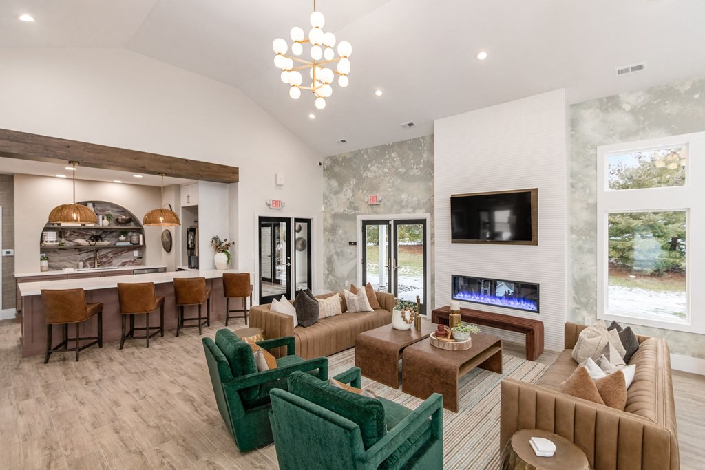 a living room with couches and chairs and a fireplace