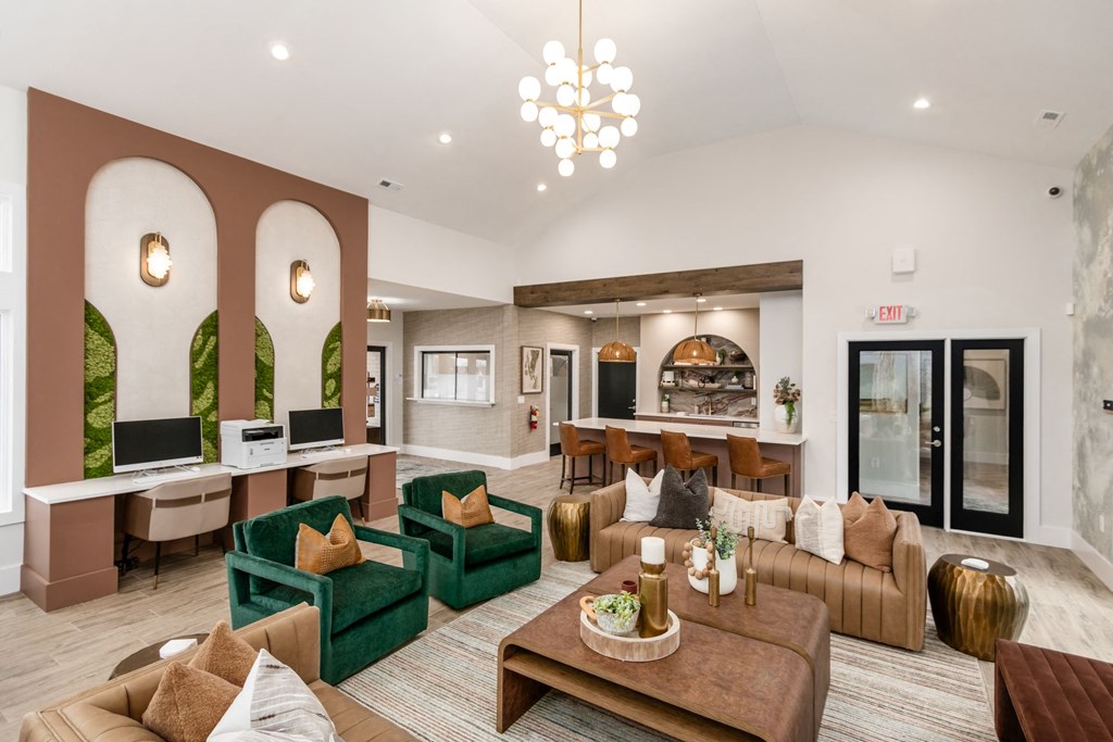 a living room with couches and chairs and a kitchen