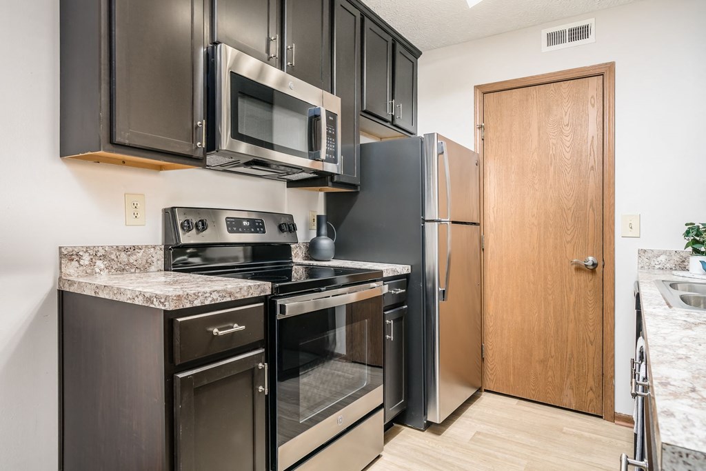 a kitchen with stainless steel appliances and a refrigerator