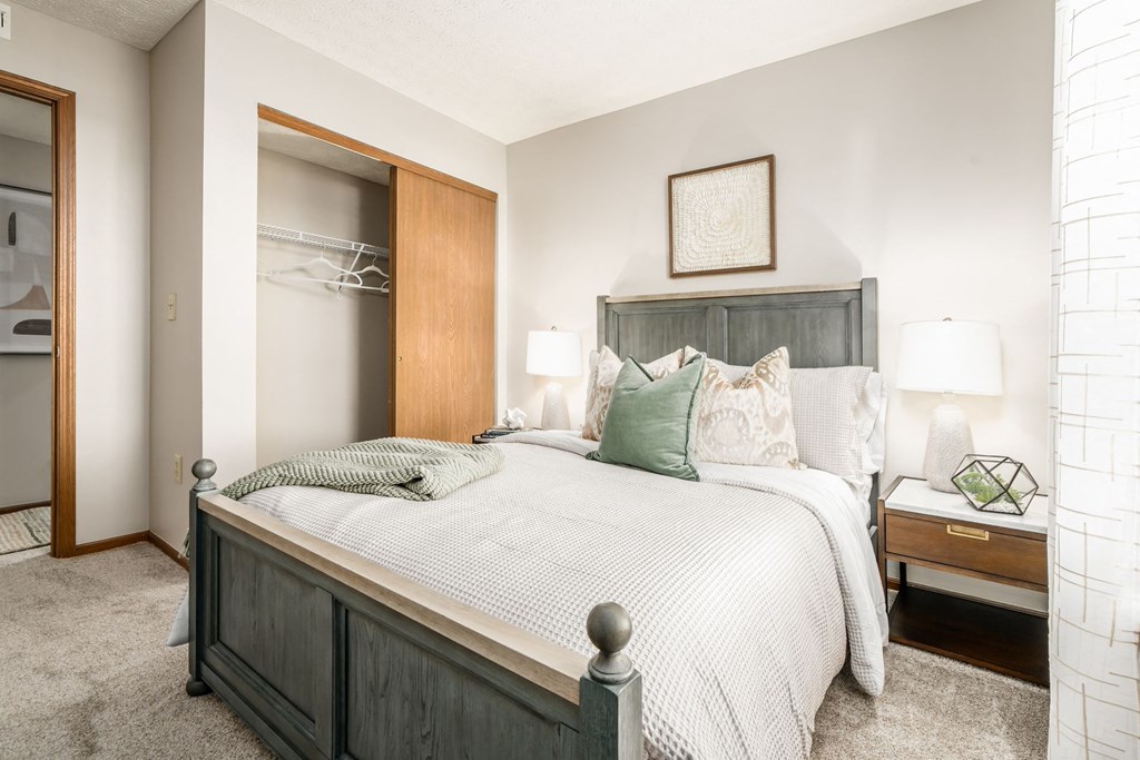 a bedroom with a large bed and a closet