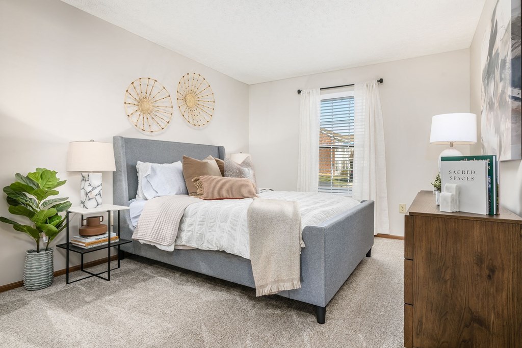 a bedroom with a bed and a window