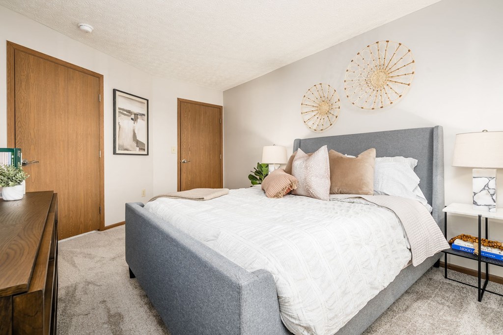 a bedroom with a bed and a closet