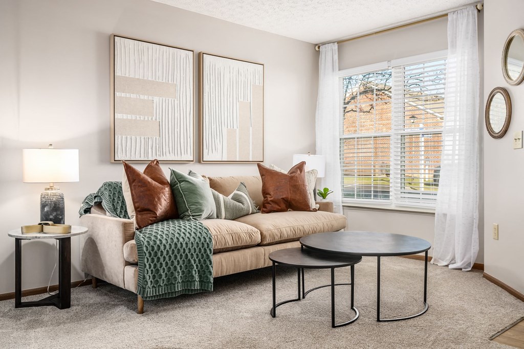 a living room with a couch and two windows