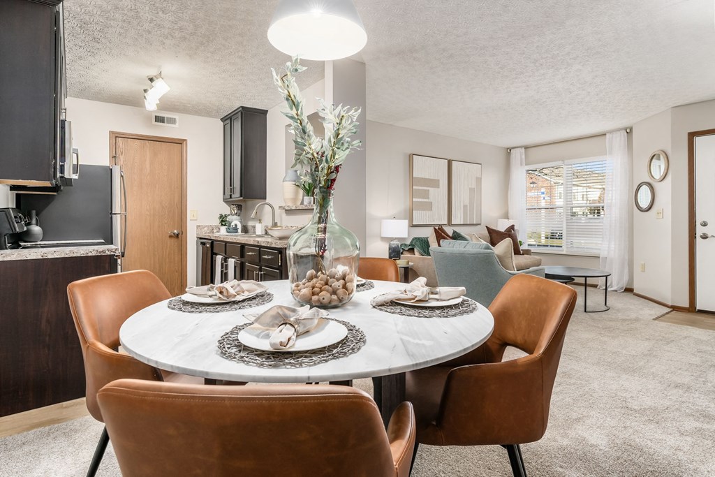 a dining room and living room with a table and chairs