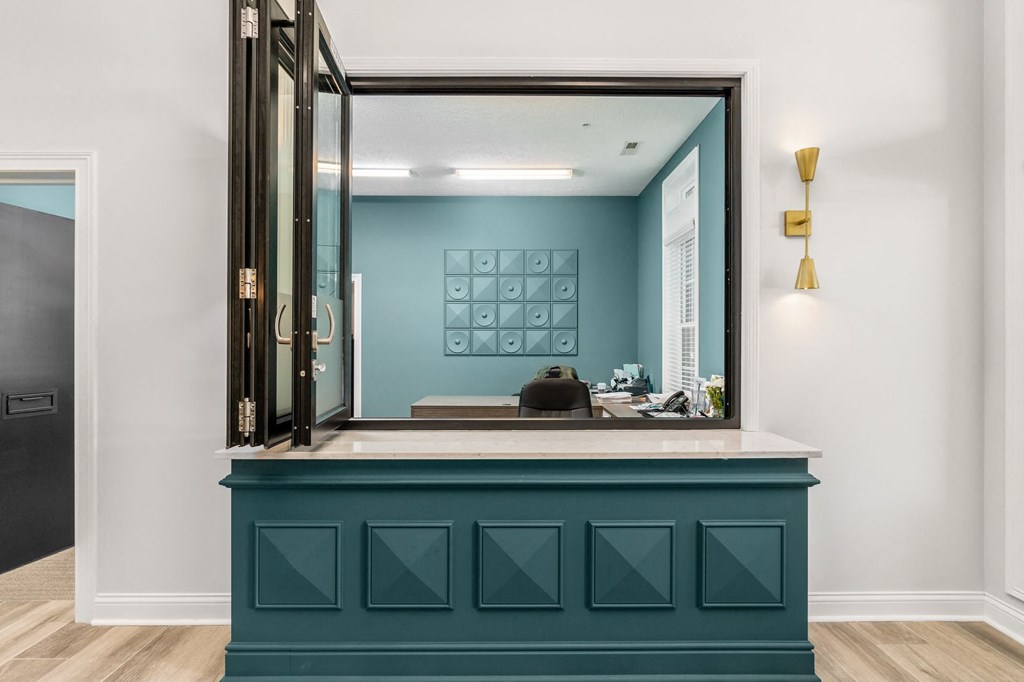a mirror over a counter in a room with a door to a bathroom