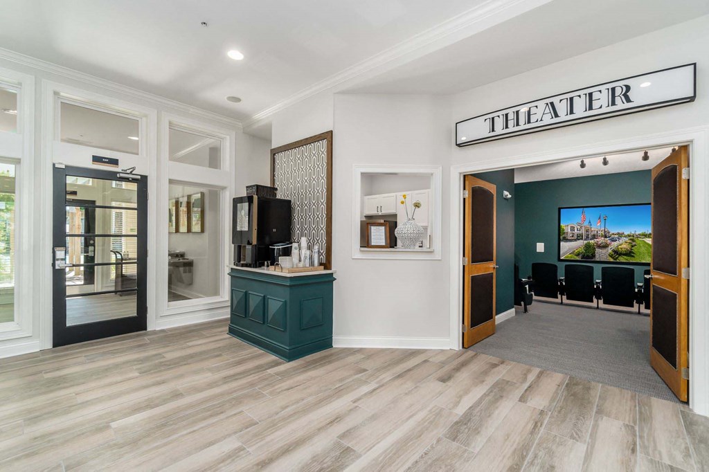 the lobby of the theater with chairs and a counter