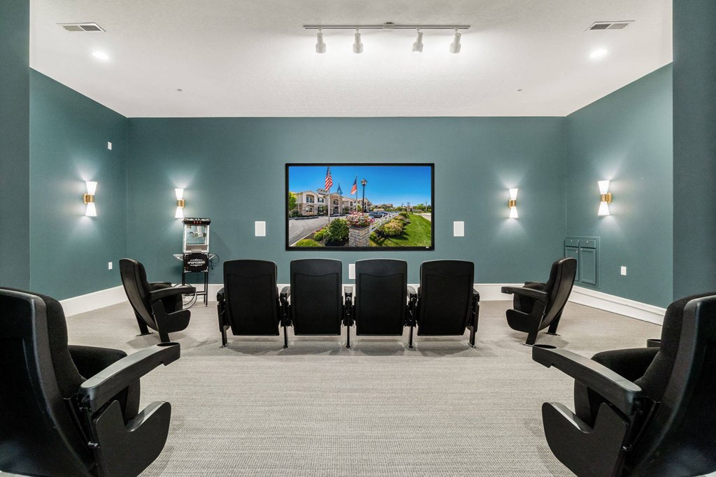 a conference room with a table and chairs and a picture on the wall
