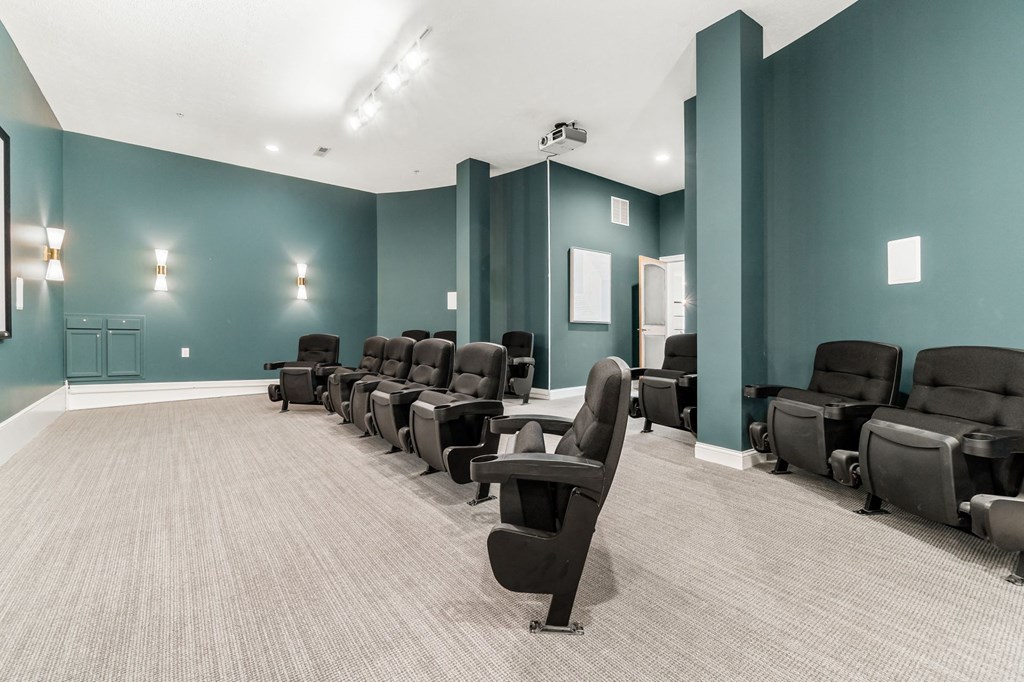 a large screening room with rows of reclining chairs