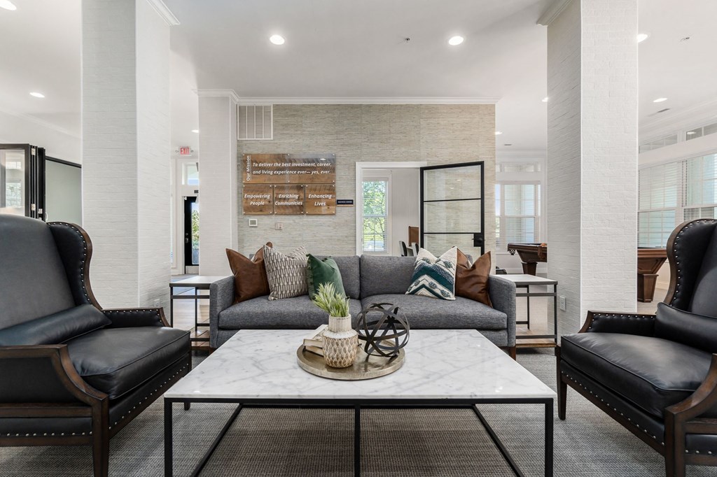 a living room with couches and chairs and a table