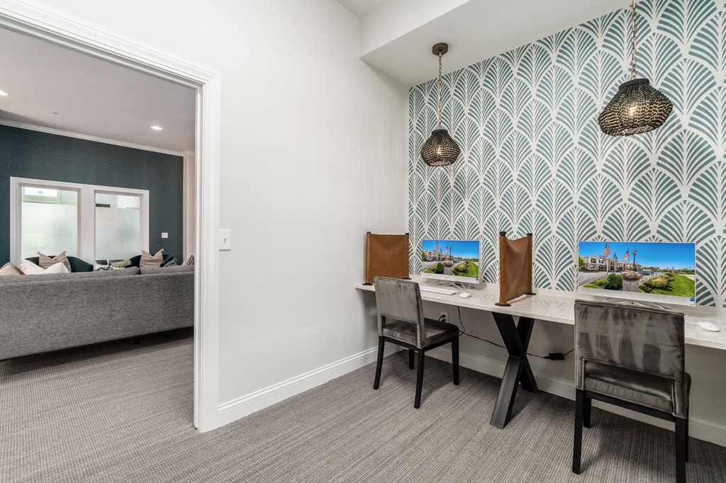 a home office with a desk and a window