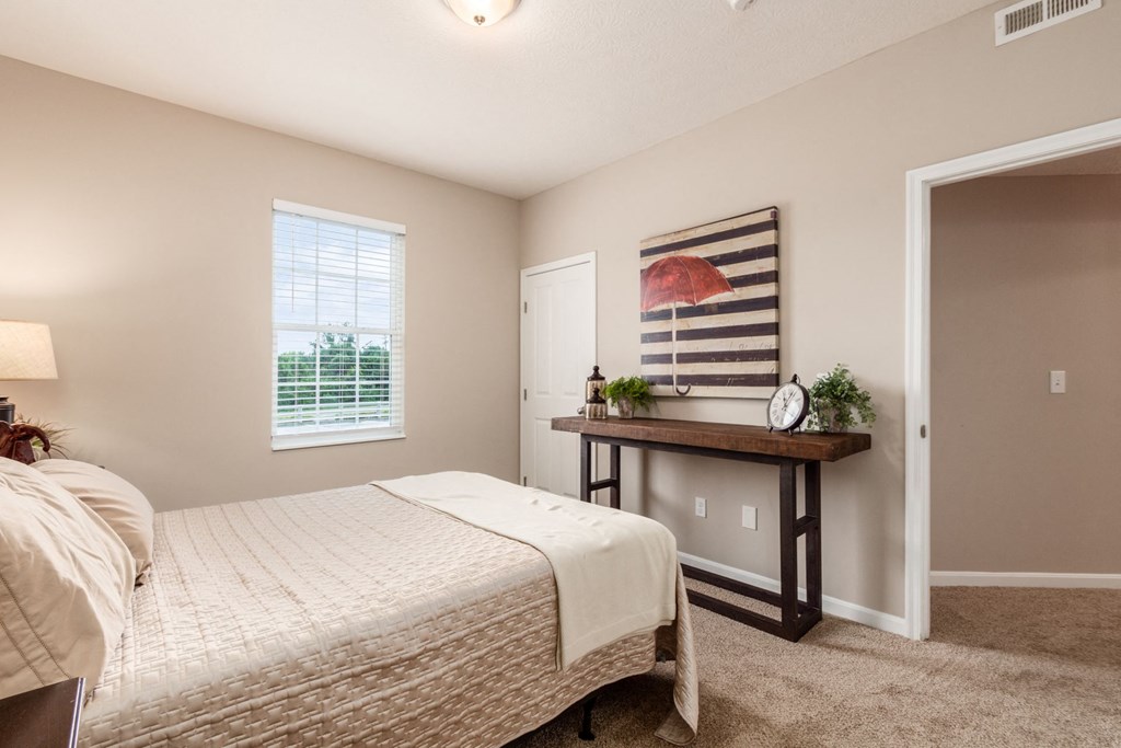 a bedroom with a bed and a window