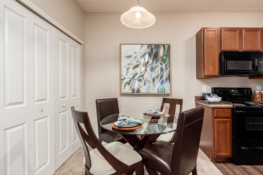 a dining room with a glass table and chairs
