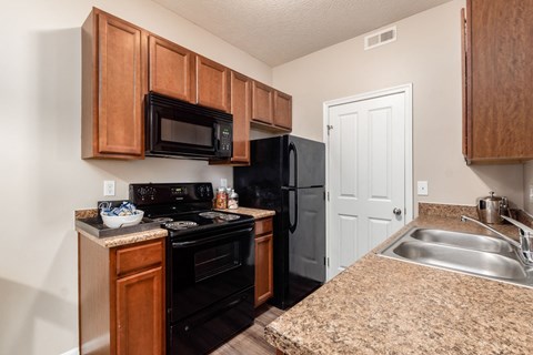 a kitchen with black appliances and granite counter tops and