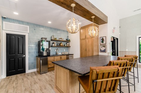 a kitchen with a large island and a table with chairs