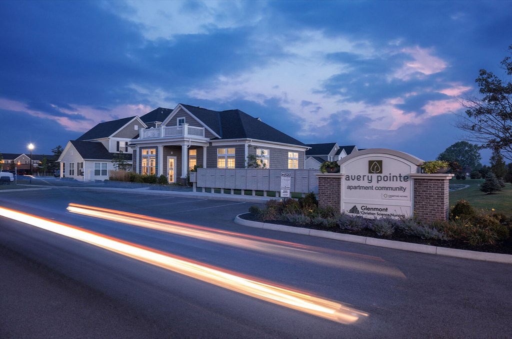 a house with a street in front of it at night