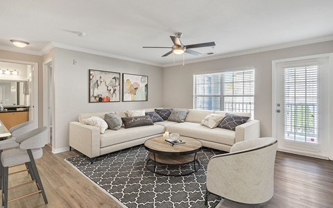 A living room with a white couch and a coffee table.