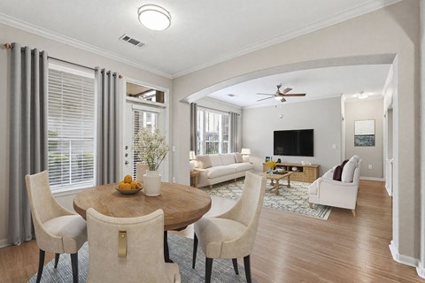 A modern dining room with a round table and chairs.