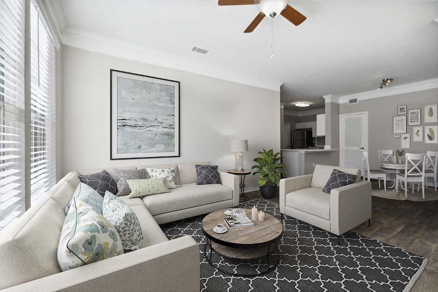a living room filled with furniture and a ceiling fan