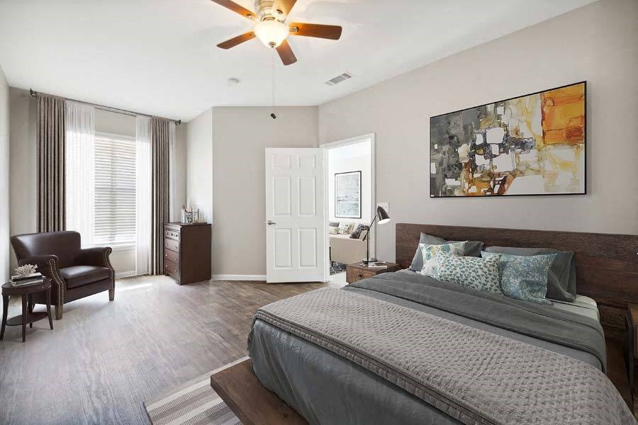 a bedroom with a large bed and a ceiling fan