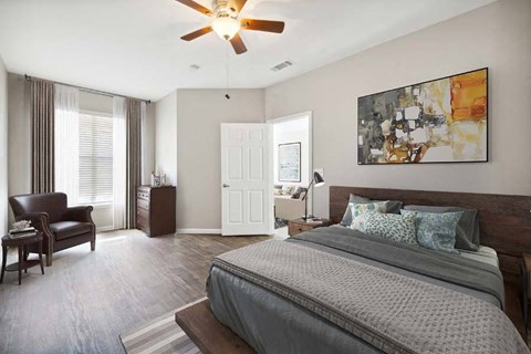 a bedroom with a large bed and a ceiling fan