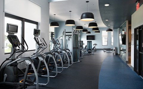 A gym with treadmills and other exercise equipment.