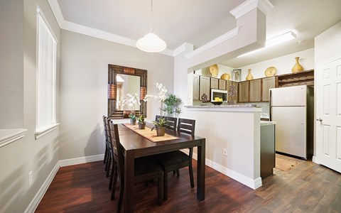 A kitchen with a table and chairs in the middle of the room.