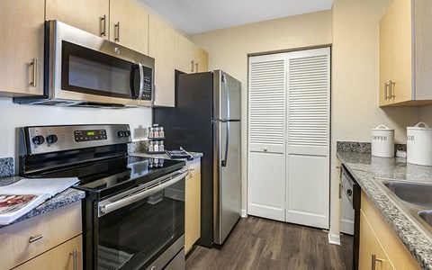 a kitchen with stainless steel appliances and a refrigerator