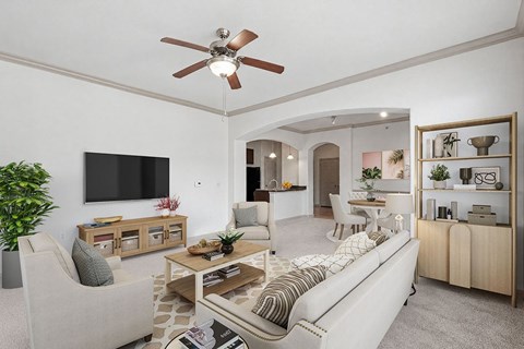 A living room with a couch, a television, and a ceiling fan.