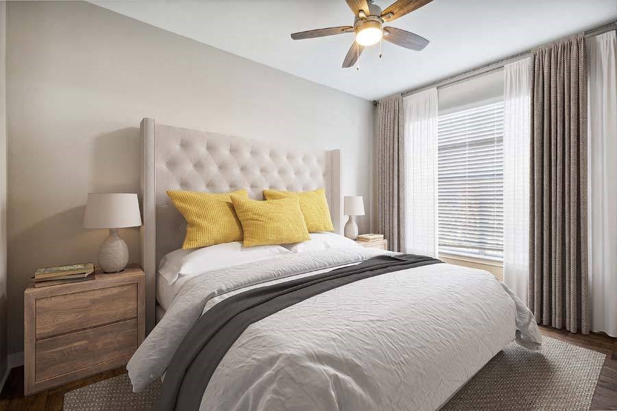 a bedroom with a bed and a ceiling fan