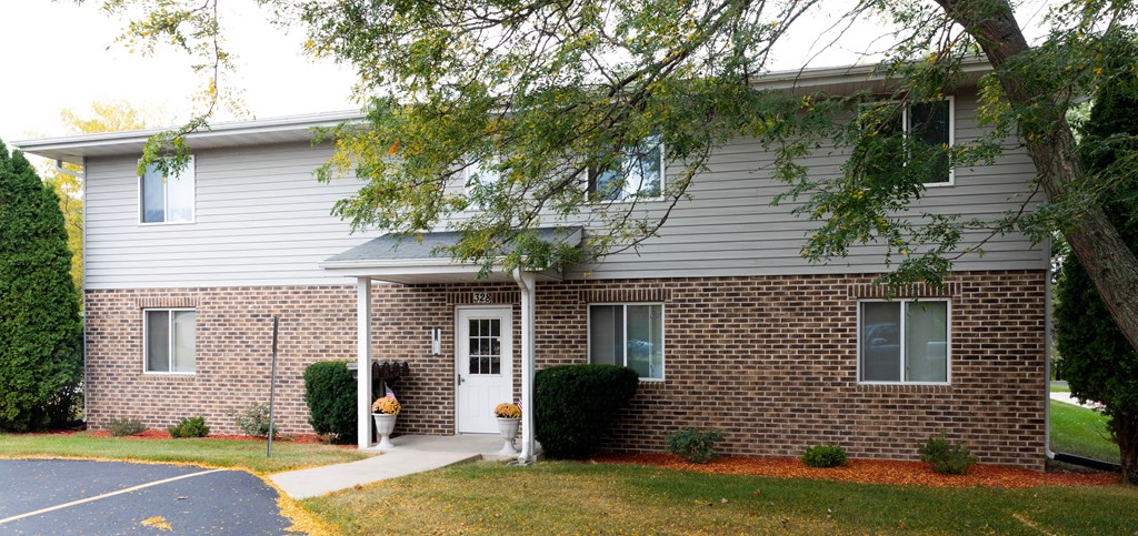 a brick and with a tree in front of it