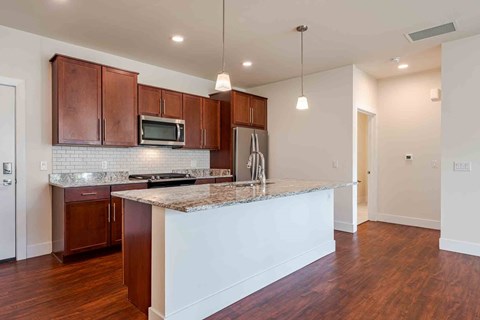 A kitchen with brown cabinets and a white island.